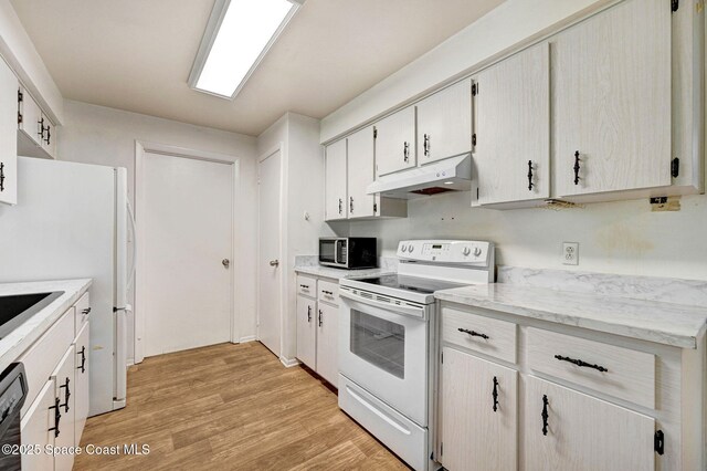1123 Hermosa Dr, Rockledge, FL 32955 - kitchen featuring white appliances, under cabinet range hood, and light wood finished floors