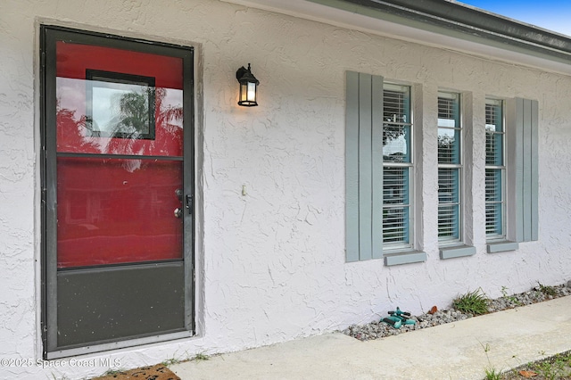 1123 Hermosa Dr, Rockledge, FL 32955 - view of exterior entry featuring stucco siding and a porch