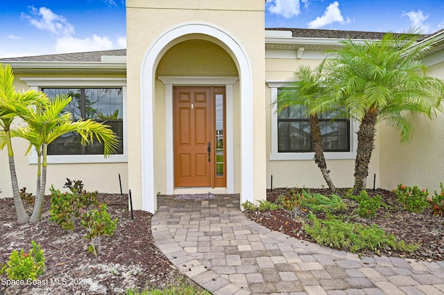 7406 Millbrook Ave, Melbourne, FL 32940 - entrance to property with stucco siding and roof with shingles