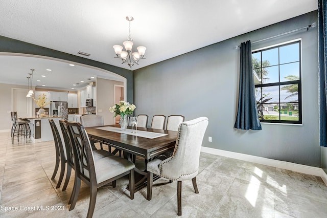 7406 Millbrook Ave, Melbourne, FL 32940 - dining space featuring arched walkways, a chandelier, and recessed lighting