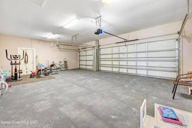 7406 Millbrook Ave, Melbourne, FL 32940 - garage featuring a garage door opener and concrete block wall