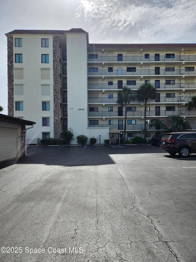 3060 N Atlantic Ave Unit 602, Cocoa Beach, FL 32931 - view of apartment building / complex featuring uncovered parking