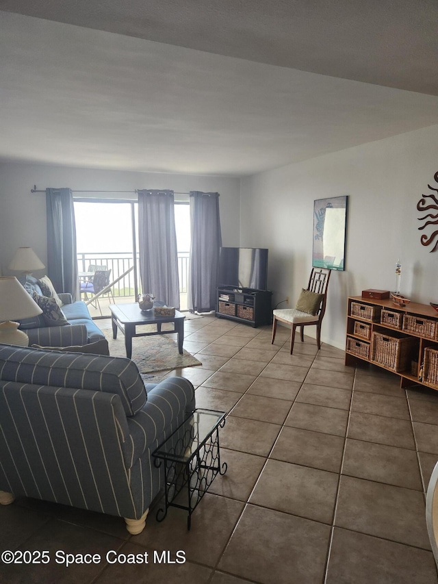 3060 N Atlantic Ave Unit 602, Cocoa Beach, FL 32931 - living room featuring tile patterned flooring