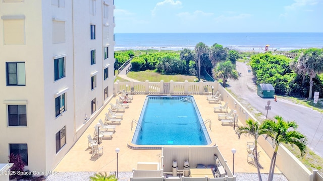 3060 N Atlantic Ave Unit 602, Cocoa Beach, FL 32931 - community pool featuring a water view and a patio