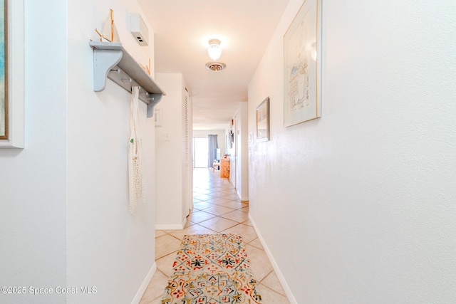 3060 N Atlantic Ave Unit 602, Cocoa Beach, FL 32931 - hall with light tile patterned floors and baseboards