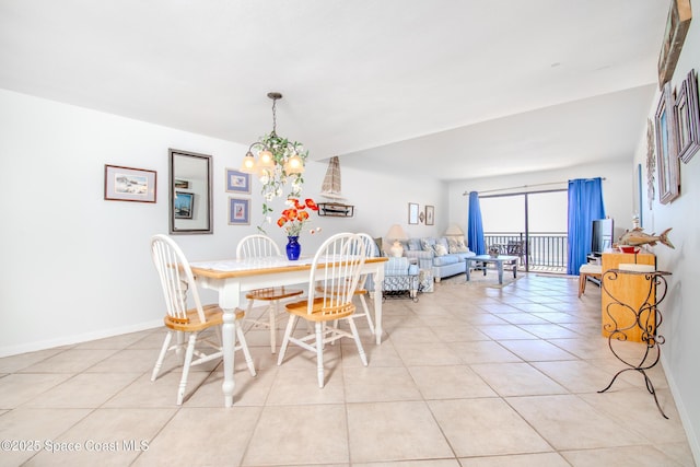 3060 N Atlantic Ave Unit 602, Cocoa Beach, FL 32931 - dining area with light tile patterned floors and a chandelier