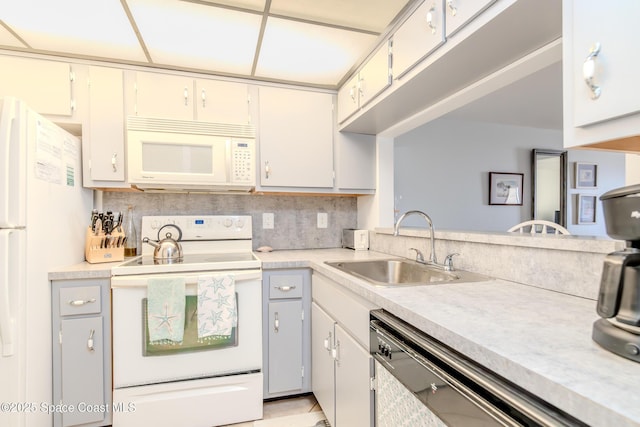 3060 N Atlantic Ave Unit 602, Cocoa Beach, FL 32931 - kitchen with white appliances, light countertops, and decorative backsplash