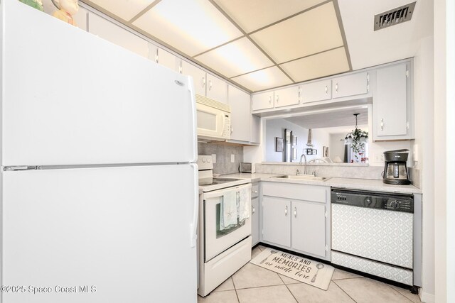 3060 N Atlantic Ave Unit 602, Cocoa Beach, FL 32931 - kitchen featuring white appliances, light countertops, and light tile patterned flooring