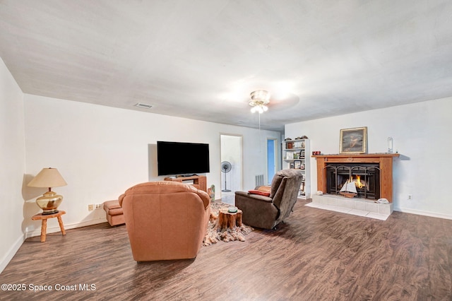 409 Stendal Rd NW, Palm Bay, FL 32907 - living room featuring wood finished floors, baseboards, and a tiled fireplace