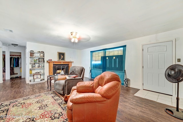 409 Stendal Rd NW, Palm Bay, FL 32907 - living area with wood finished floors, a lit fireplace, baseboards, and a ceiling fan