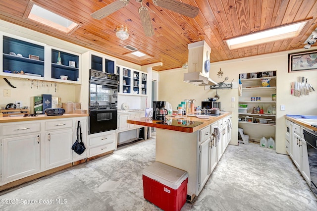 409 Stendal Rd NW, Palm Bay, FL 32907 - kitchen with black appliances, wood ceiling, open shelves, a skylight, and white cabinetry