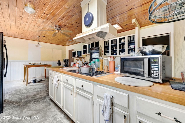 409 Stendal Rd NW, Palm Bay, FL 32907 - kitchen with wooden ceiling, stainless steel microwave, white cabinetry, a ceiling fan, and black electric cooktop