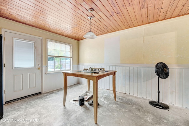 409 Stendal Rd NW, Palm Bay, FL 32907 - dining area with concrete floors, wooden ceiling, and a wainscoted wall
