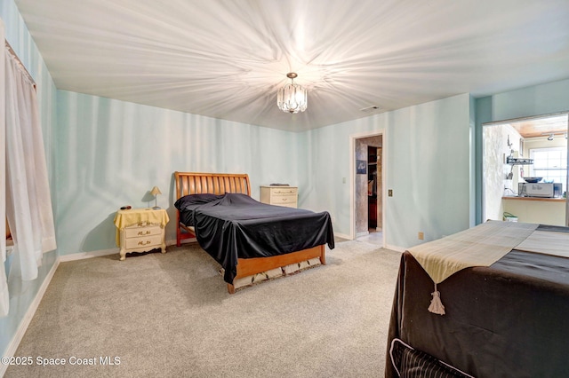 409 Stendal Rd NW, Palm Bay, FL 32907 - bedroom featuring light colored carpet, a chandelier, baseboards, and a spacious closet