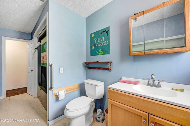 409 Stendal Rd NW, Palm Bay, FL 32907 - bathroom featuring toilet, a textured ceiling, vanity, tile patterned flooring, and baseboards