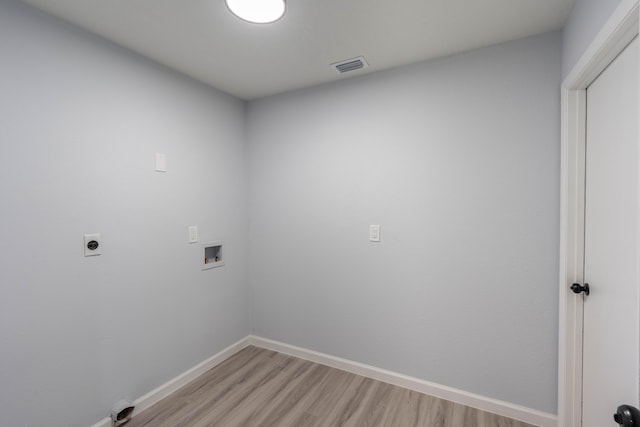 306 Harvey Ave NE, Palm Bay, FL 32907 - washroom featuring light wood-type flooring, washer hookup, baseboards, and hookup for an electric dryer