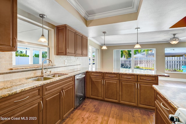 1455 Centaurus Ct, Merritt Island, FL 32953 - kitchen featuring stainless steel dishwasher, brown cabinets, ornamental molding, dark wood-style floors, and tasteful backsplash