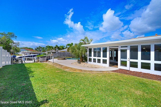 1455 Centaurus Ct, Merritt Island, FL 32953 - view of yard featuring a sunroom, a boat dock, and boat lift