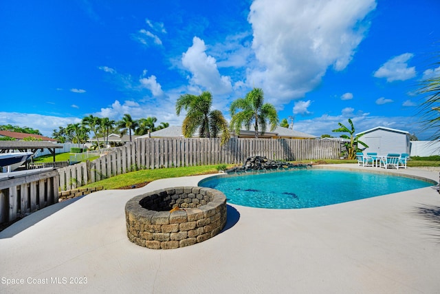1455 Centaurus Ct, Merritt Island, FL 32953 - view of swimming pool featuring a patio, a fenced backyard, and a fire pit
