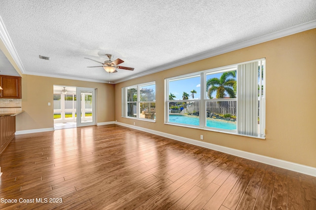 1455 Centaurus Ct, Merritt Island, FL 32953 - unfurnished living room with ceiling fan, a textured ceiling, wood finished floors, and ornamental molding
