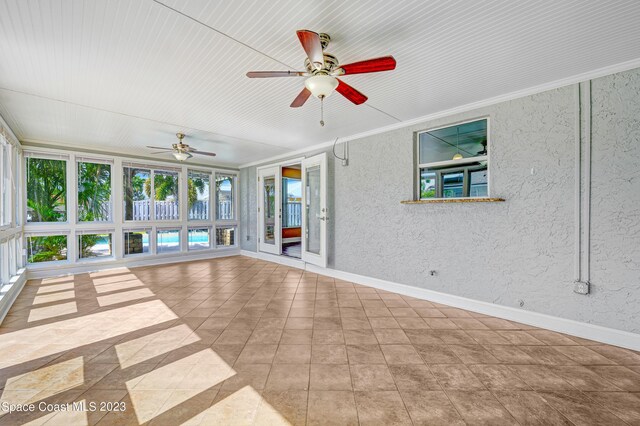 1455 Centaurus Ct, Merritt Island, FL 32953 - unfurnished sunroom featuring a textured wall and crown molding