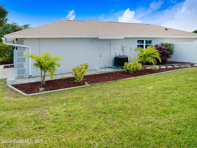 1455 Centaurus Ct, Merritt Island, FL 32953 - view of property exterior featuring stucco siding and roof with shingles