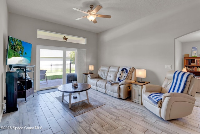4070 Sage Brush Cir, Melbourne, FL 32901 - living room featuring a ceiling fan, light wood finished floors, and arched walkways