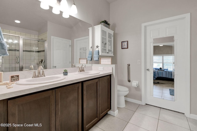 4070 Sage Brush Cir, Melbourne, FL 32901 - ensuite bathroom featuring double vanity, a stall shower, tile patterned flooring, and a chandelier