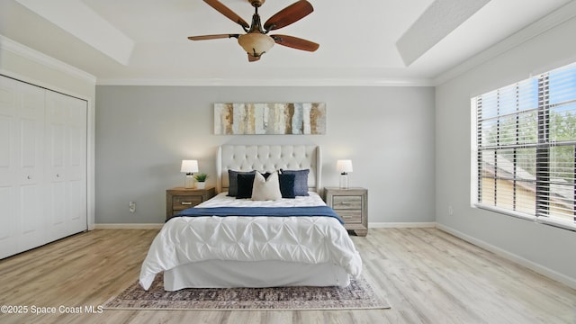 1160 Luminary Cir Unit 105, Melbourne, FL 32901 - bedroom with a tray ceiling, wood finished floors, baseboards, ornamental molding, and ceiling fan
