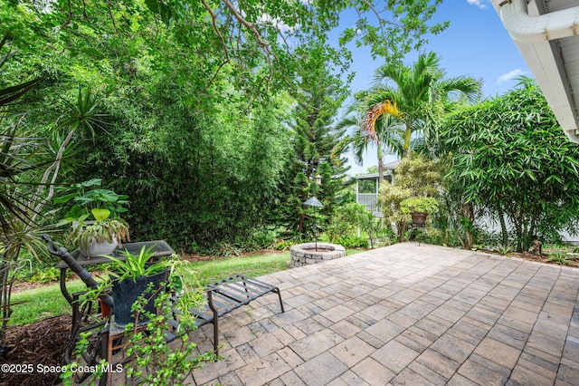 3469 Horse Creek Cir, Melbourne, FL 32935 - view of patio / terrace with an outdoor fire pit