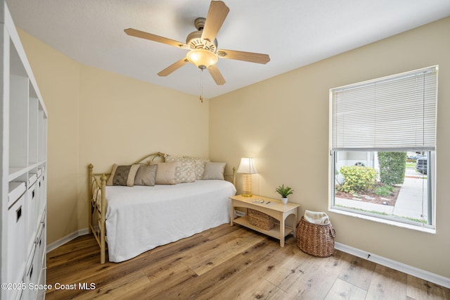 3469 Horse Creek Cir, Melbourne, FL 32935 - bedroom with wood finished floors, baseboards, and a ceiling fan