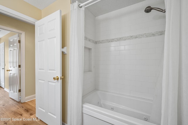 3469 Horse Creek Cir, Melbourne, FL 32935 - full bathroom with a combined bath / shower with jetted tub, wood finished floors, and baseboards