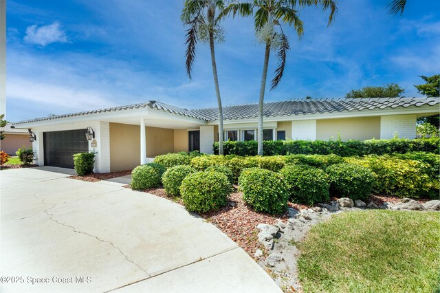 630 Seville Ct, Satellite Beach, FL 32937 - ranch-style home featuring a garage, concrete driveway, and brick siding