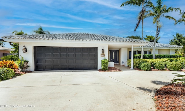 630 Seville Ct, Satellite Beach, FL 32937 - ranch-style home featuring concrete driveway, a garage, and a tile roof