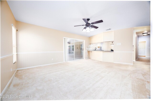 630 Seville Ct, Satellite Beach, FL 32937 - unfurnished living room featuring ceiling fan and light colored carpet
