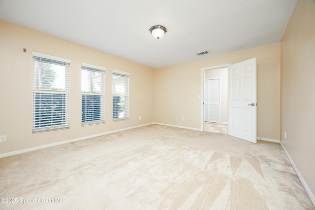 630 Seville Ct, Satellite Beach, FL 32937 - spare room featuring light carpet