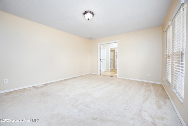 630 Seville Ct, Satellite Beach, FL 32937 - spare room featuring light colored carpet and baseboards