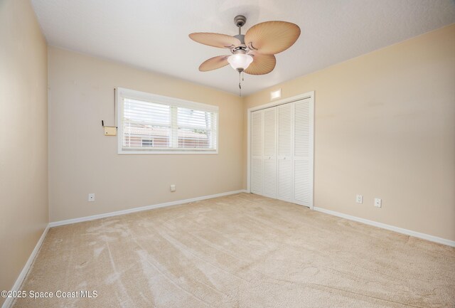 630 Seville Ct, Satellite Beach, FL 32937 - unfurnished bedroom with light colored carpet, a closet, and ceiling fan