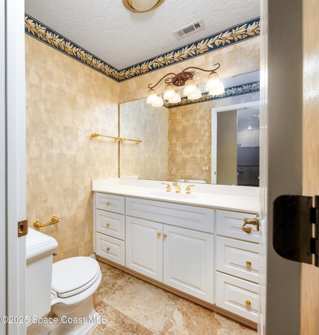 630 Seville Ct, Satellite Beach, FL 32937 - bathroom featuring vanity and a textured ceiling