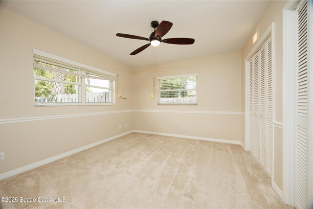 630 Seville Ct, Satellite Beach, FL 32937 - unfurnished bedroom featuring carpet floors and a ceiling fan