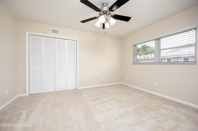630 Seville Ct, Satellite Beach, FL 32937 - unfurnished bedroom with light carpet, a closet, and a ceiling fan