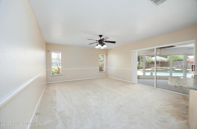 630 Seville Ct, Satellite Beach, FL 32937 - carpeted empty room with healthy amount of natural light and ceiling fan