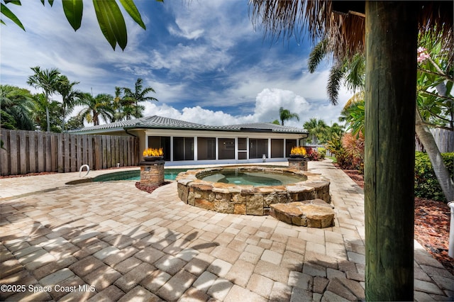 630 Seville Ct, Satellite Beach, FL 32937 - view of swimming pool with an in-ground hot tub, a sunroom, a patio area, and a fenced backyard