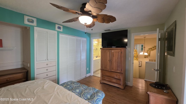8714 Jasmine Ct, Cape Canaveral, FL 32920 - bedroom with wood finished floors, baseboards, connected bathroom, and a ceiling fan