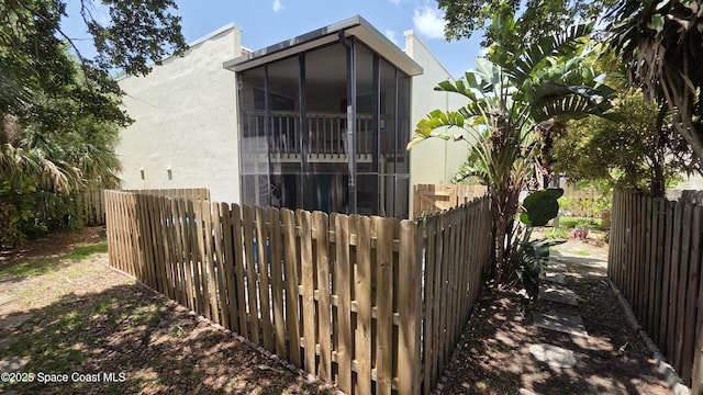 8714 Jasmine Ct, Cape Canaveral, FL 32920 - view of property exterior featuring stucco siding and a sunroom