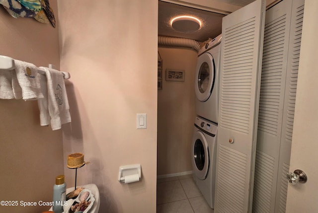 8714 Jasmine Ct, Cape Canaveral, FL 32920 - laundry area featuring stacked washer and clothes dryer and light tile patterned flooring