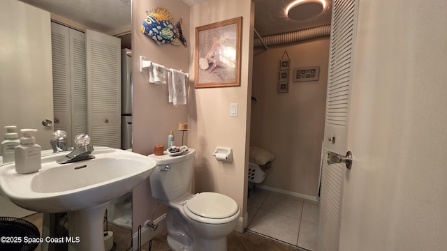 8714 Jasmine Ct, Cape Canaveral, FL 32920 - half bathroom featuring a closet, tile patterned flooring, and toilet