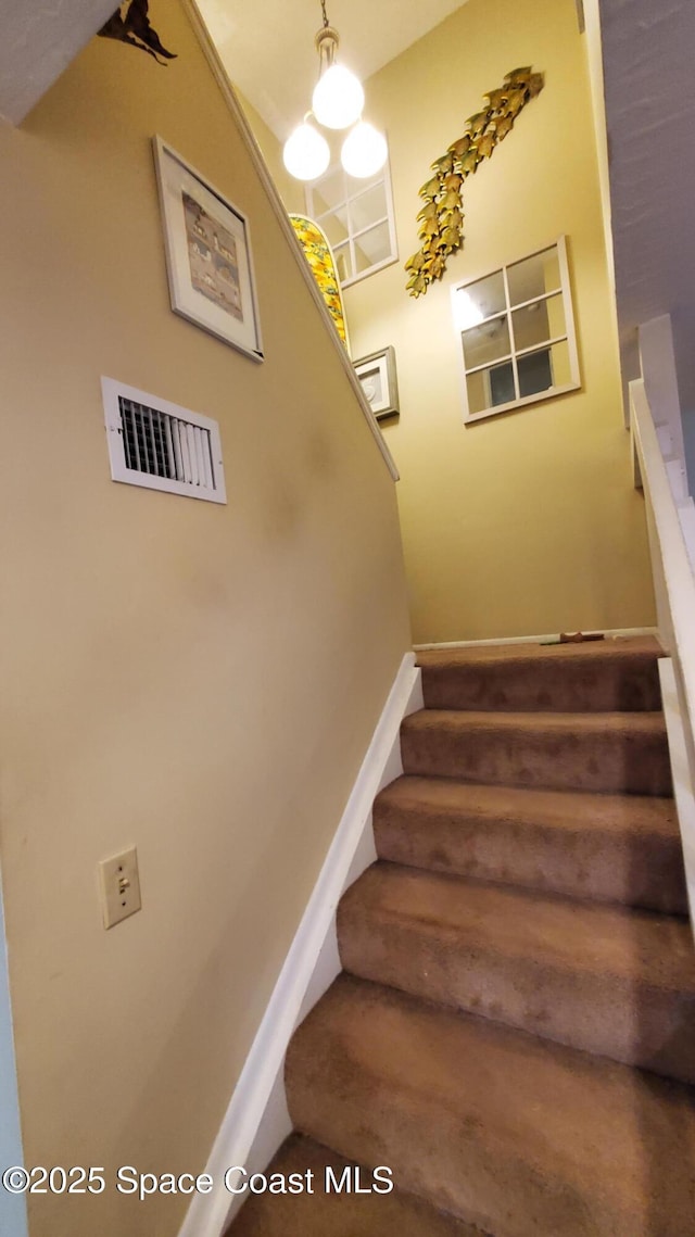 8714 Jasmine Ct, Cape Canaveral, FL 32920 - stairway with baseboards
