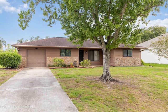 662 Estaugh St NW, Palm Bay, FL 32907 - view of front of house featuring stone siding, concrete driveway, a garage, a front lawn, and roof with shingles