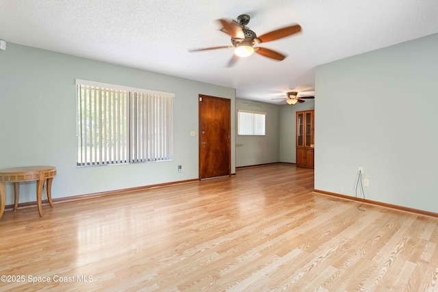 662 Estaugh St NW, Palm Bay, FL 32907 - empty room featuring a ceiling fan, wood finished floors, and baseboards